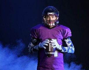 American football player on dark background