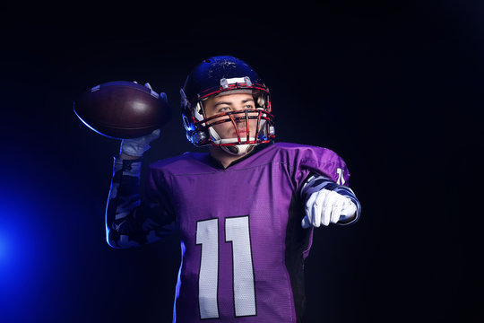 American football player on dark background © Pixel-Shot