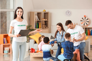 Volunteers with donations and children at orphan home