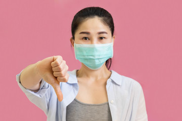 Young asian woman wore a gray undershirt, Blue shirt and protective masks against virus and air...
