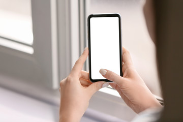 Young woman with mobile phone at home
