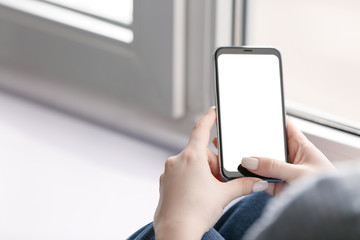 Young woman with mobile phone at home