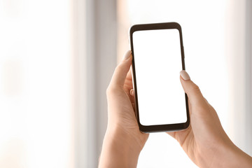 Young woman with mobile phone at home