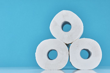 Consumer buying panic about coronavirus covid-19 concept. Toilet paper rolls on a blue background. People are stocking up essentials for home quarantine