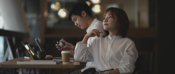 Close up view of female photographer sitting at modern workplace