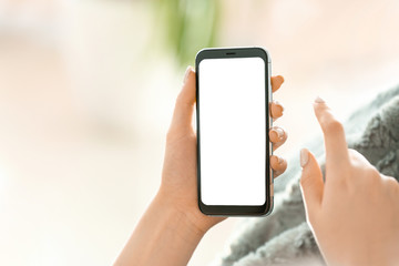 Young woman with mobile phone at home