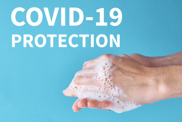 Concept of COVID-19 outbreak health protection with the antiseptic. Woman wash hands using sanitizer or antiseptic gel as prevention measure for coronavirus on blue background