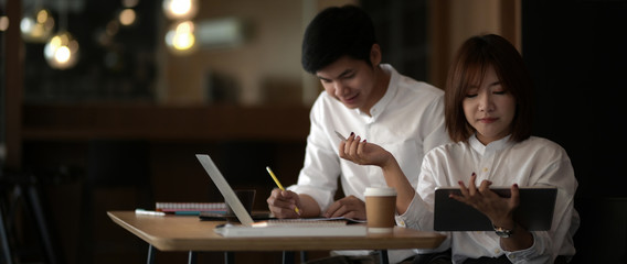 Cropped shot of two businesspeople concentrating on their work