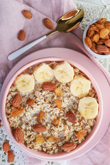 Bowl with tasty sweet oatmeal on tray
