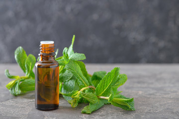 Bottle of mint essential oil on table