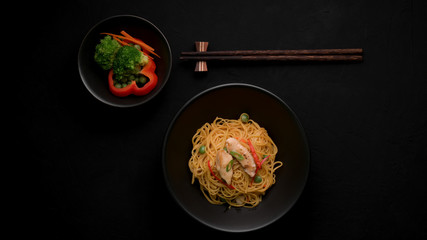 Top view of Schezwan Noodles or Chow Mein with vegetable, chicken and chilli sauce
