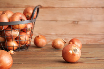 Fresh raw onion on wooden table