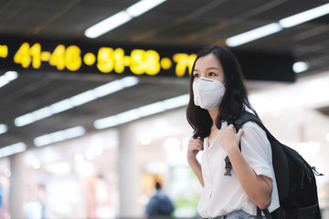 Asian travelers girl with surgical face mask to protection the covid-19 in airport