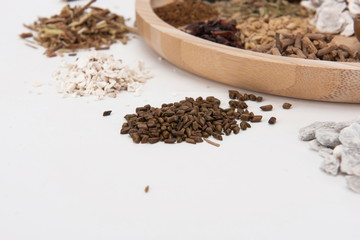 A group of herbs on a white background, large Chinese herbs in a wooden bowl, close-up of medicinal plants and aromatic plants
