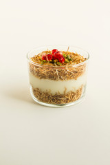 Traditional,milky,crispy Ramadan dessert custard pudding made with roasted kadayif,pomegranate...