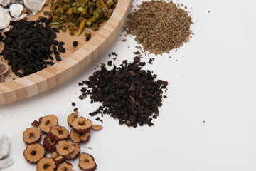 A group of herbs on a white background, large Chinese herbs in a wooden bowl, close-up of medicinal plants and aromatic plants