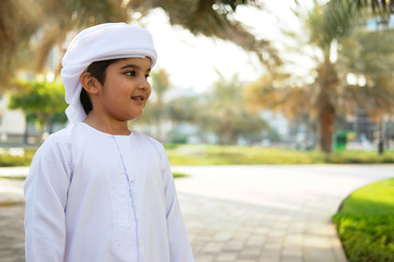 Portrait of young boy wearing Kandura for kids. Handsome Emirati child 