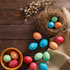 Still life of easter eggs in a bird's nest on a wooden background. Rustic. Decoration of natural. Easter celebration concept. Copy space. Flat lay. Square.