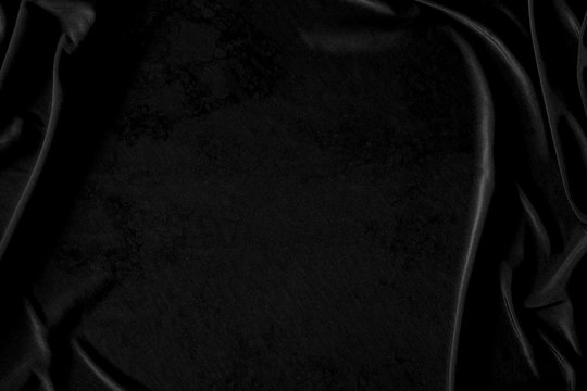 Black Dark gray luxury cloth abstract background. Detail fabric of pattern grunge silk texture satin velvet material, luxurious. Crumpled textile shiny black. Design, elegance with vignette effect.