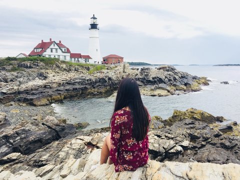 Woman enjoying beautiful view of Portland lighthouse in Portland Maine USA