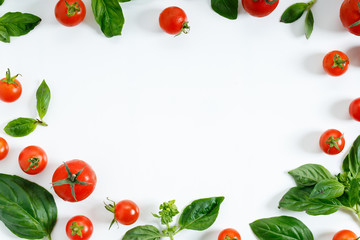 red cherry tomato and basil leaf on white background
