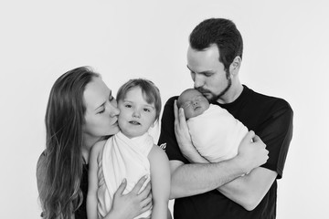 concept of healthy lifestyle, protection of children, shopping - baby in the arms of the mother and father. Woman and man holding a child. Isolated on white background. Copy space. Portrait of faamily