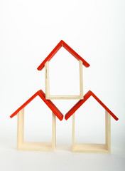 wooden mini house on the white background as business, family and property concept