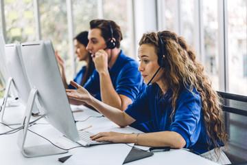 Group of happy call center smiling business operator customer support team phone services agen...