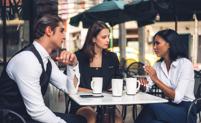 Group of cheerful young friend discussing meeting and talk enjoying their time drinking coffee together.Mixed race people sitting at cafe table and restaurant