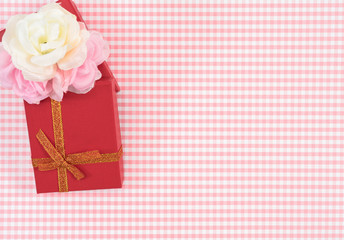 gift box with red isolated on Plaid background. Holiday decoration for Mother's Day or Women's Day.