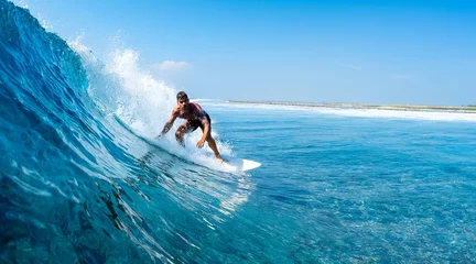 Foto op Plexiglas Young man surfs ocean wave in Maldives © Dudarev Mikhail