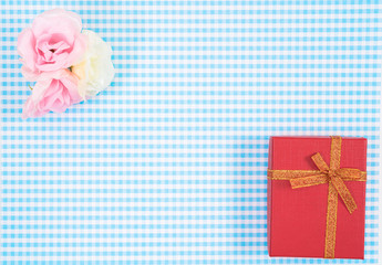 gift box with red isolated on Plaid background. Holiday decoration for Mother's Day or Women's Day.