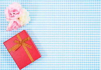 gift box with red isolated on Plaid background. Holiday decoration for Mother's Day or Women's Day.