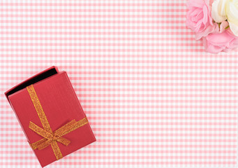 gift box with red isolated on Plaid background. Holiday decoration for Mother's Day or Women's Day.