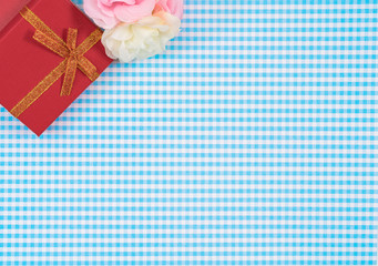 gift box with red isolated on Plaid background. Holiday decoration for Mother's Day or Women's Day.