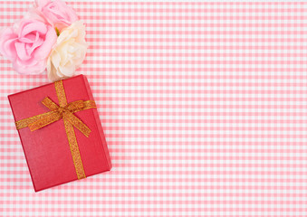 gift box with red isolated on Plaid background. Holiday decoration for Mother's Day or Women's Day.