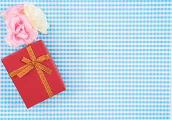 gift box with red isolated on Plaid background. Holiday decoration for Mother's Day or Women's Day.