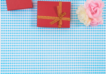 gift box with red isolated on Plaid background. Holiday decoration for Mother's Day or Women's Day.