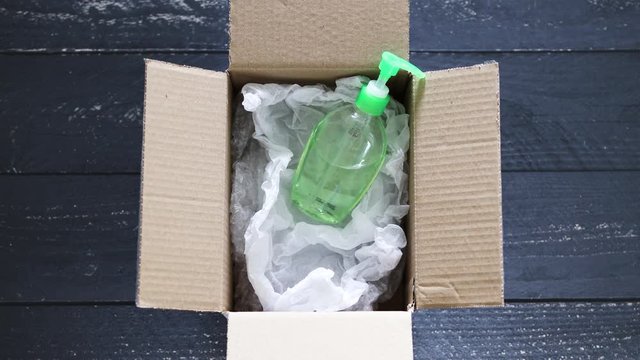 hand sanitizer bottle inside delivery parcel symbol highly sought after products in times of self-isolation and quarantines with camera defocusing