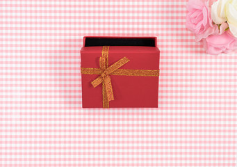 gift box with red isolated on Plaid background. Holiday decoration for Mother's Day or Women's Day.