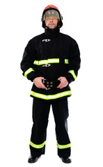 Full-length portrait of a man in black uniform of a fireman with a red helmet on a white isolated background. The model stands right in front of the camera. Studio photo.