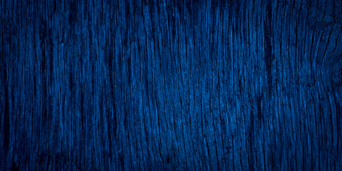 The texture of navy blue wood. Texture of old dried plywood. Classic blue background for design.