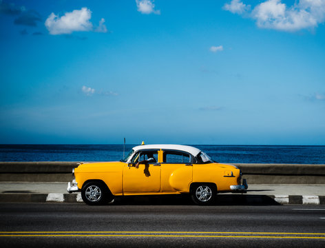 1950's car driving along the Malecon on a sunny day, Havana, Cuba, Central America