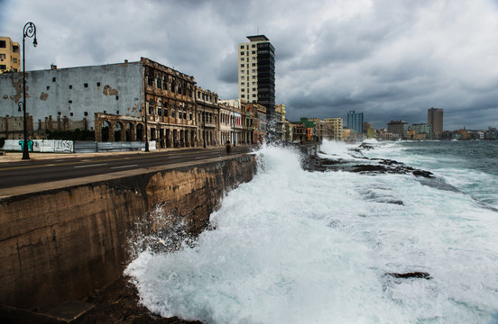 Waves crashing along the Malecon on a cloudy day, Havana, Cuba, Central America