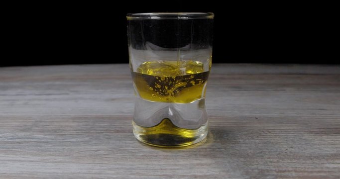 Olive oil pouring into glass 120p