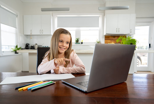 Coronavirus School Closures And Lockdown. Schoolgirl Talking With Teacher On A Online Class At Home