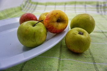 apples in a bowl on table