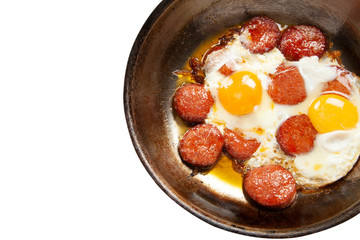 Copper pan with fried egg and sausage
