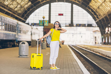 woman at railway station waiting for train