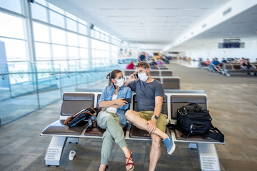 Coronavirus outbreak travel restrictions. Traveler with mask at airport affected by the travel ban...